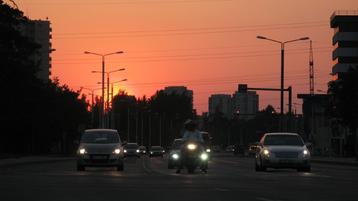 Headlamps in traffic with a red sunset