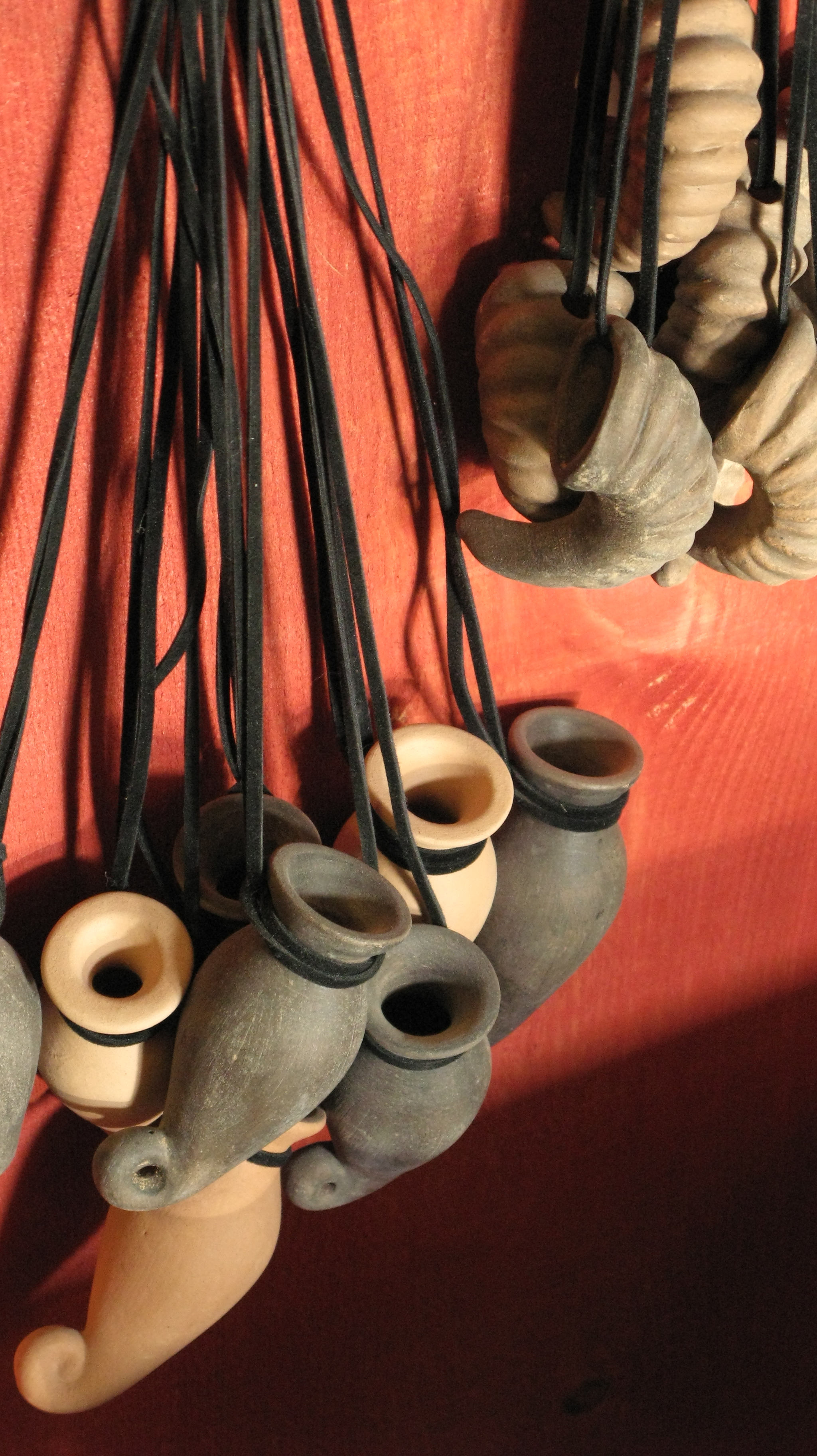 Miniature pottery works hanging on strings