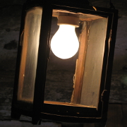 A wooden lantern with a light bulb