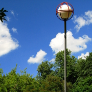 Shot of a skewed street lamp taken so it would appear straight up, a park in the background